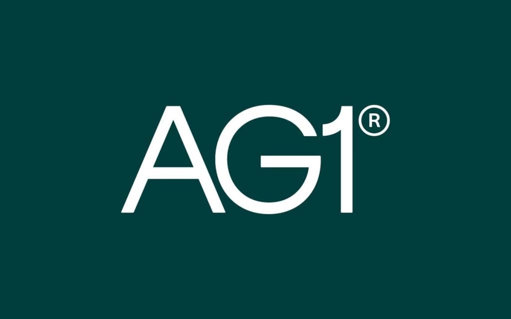 The design is minimalist and professional, utilizing a clean sans-serif typeface in white against a deep, dark teal background. The composition is centered and relies on strong negative space to emphasize the bold initials 'AG1' and the registered trademark symbol.