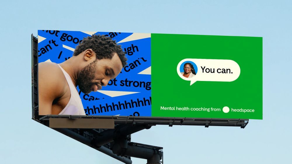The image is a billboard or large outdoor advertisement featuring a split design with contrasting colors and text. It uses bold, simple typography against a bright background to convey a message related to mental health coaching.