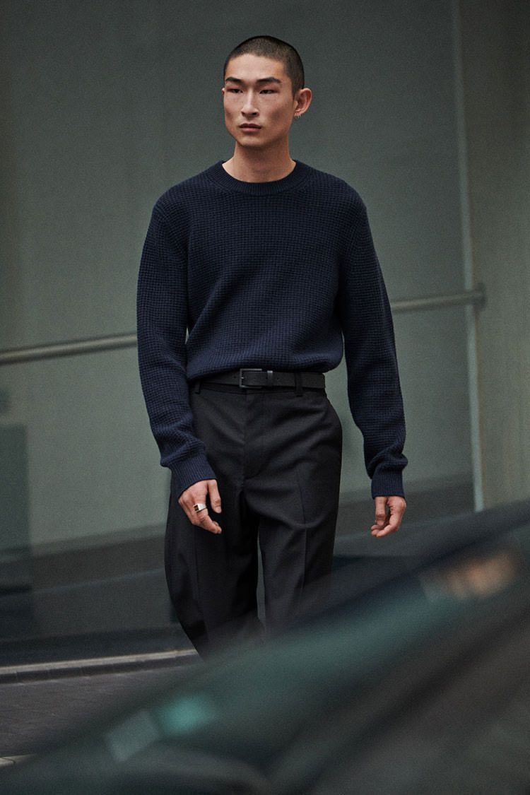 Fashion apparel photography featuring minimalist clothing styling. Clean, neutral tones with focus on fabric texture and silhouette. High-end fashion aesthetic with simple composition.