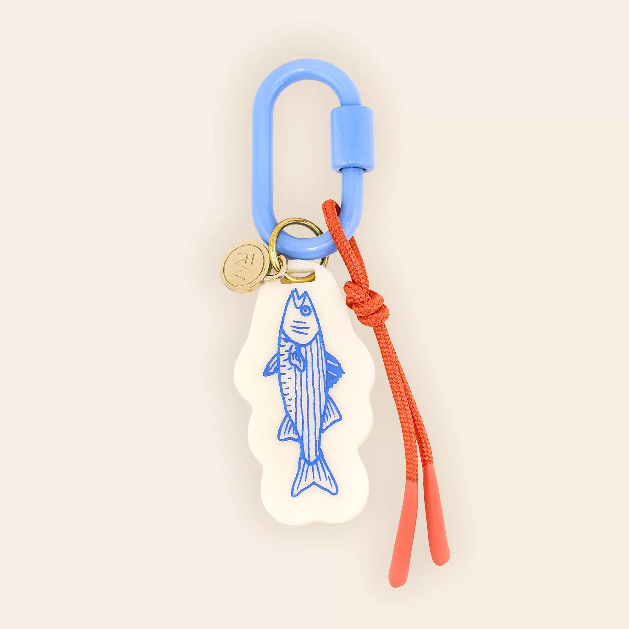 A minimalist product keychain featuring a blue carabiner clip with a cream-colored fish-shaped tag adorned with blue line-art detailing. The design combines functional outdoor gear aesthetics with playful, illustrative charm, suspended against a soft neutral background.