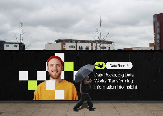 A contemporary urban mural featuring a portrait-based design with geometric elements and motivational messaging about data analytics. The composition blends photography with graphic design, set against an industrial cityscape backdrop with a bold black background that creates strong visual contrast.