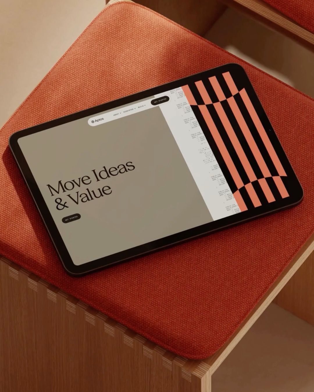 The image showcases a modern, clean interface design displayed on a tablet resting on a textured, warm-toned surface. The visual language is minimalist and structured, utilizing strong geometric patterns in the background to provide visual interest without overwhelming the main content area.