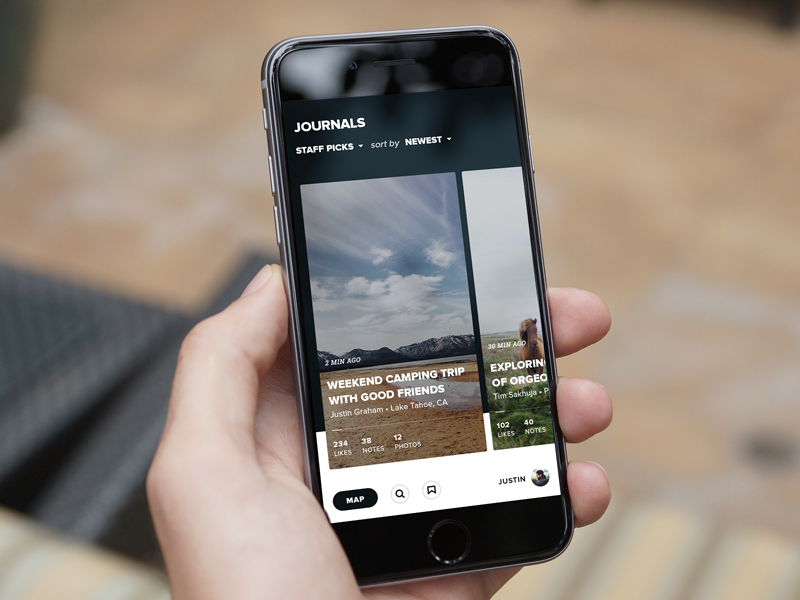 This image captures a close-up of a smartphone displaying a curated list of journals or articles, showcasing a clean, modern user interface. The design emphasizes readability and a minimalist aesthetic with high-contrast elements.