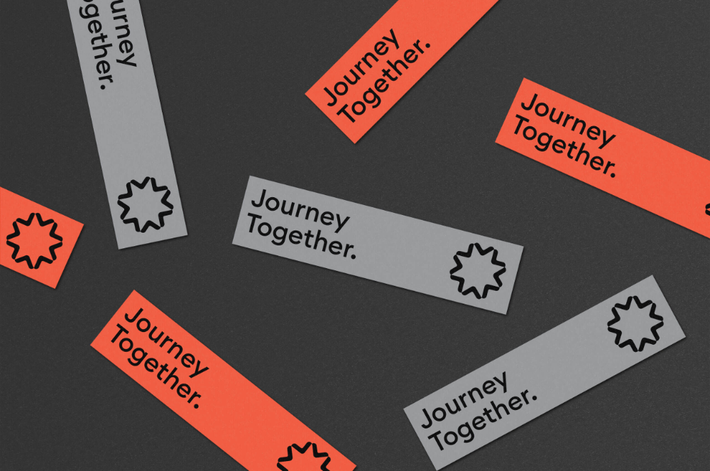 The image features several rectangular banners with the repeated text 'Journey Together' scattered across a dark, neutral background. The design relies on simple geometric shapes and contrasting color accents to create a sense of movement or layered information.