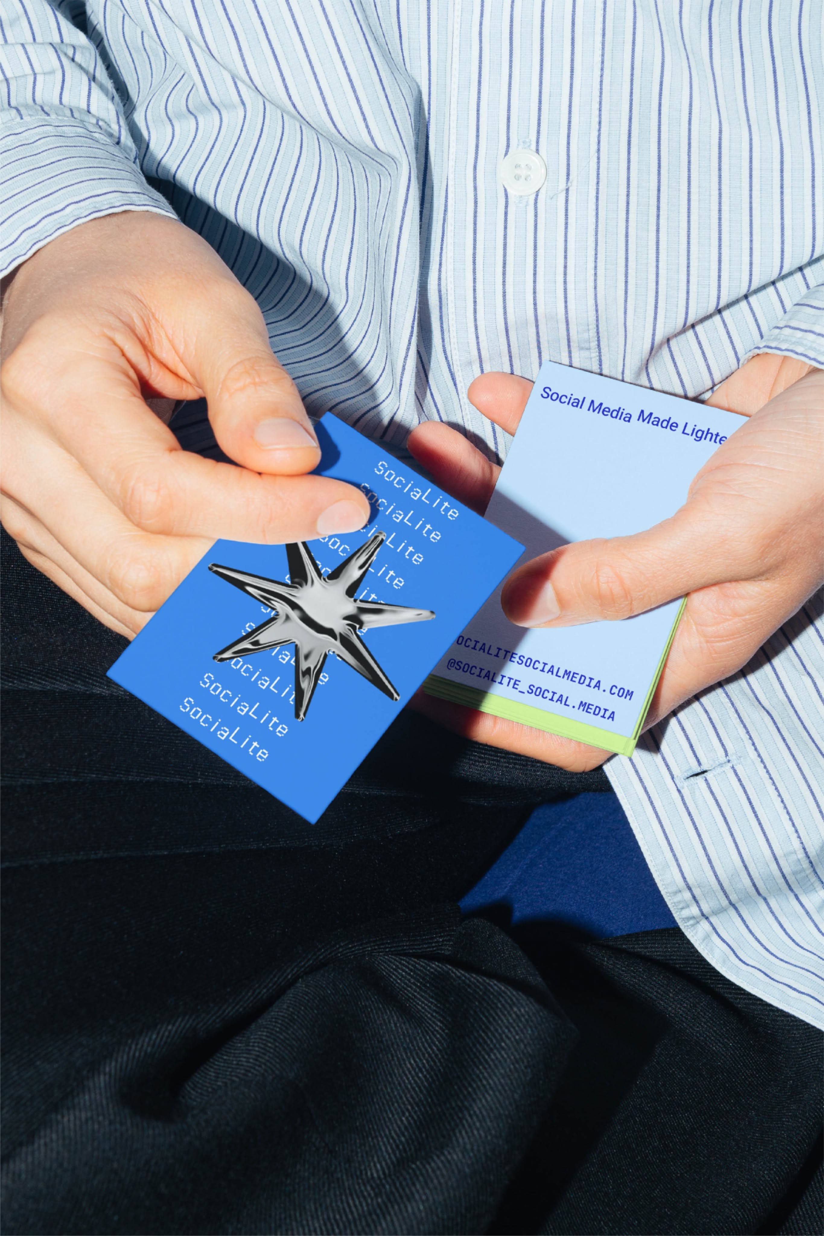 This image captures a close-up of hands presenting small, branded cards against a professional backdrop. The design utilizes clean lines and contrasting shades of blue to create a sense of modern, trustworthy corporate branding.