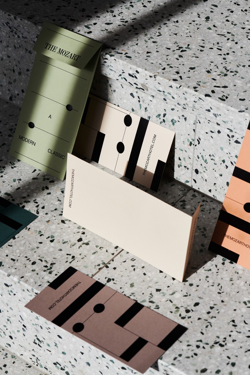 This image showcases a minimalist and sophisticated collection of cards or labels, utilizing muted, earthy tones and clean geometric shapes. The visual language emphasizes subtlety, texture, and a refined, modern aesthetic suitable for high-end branding or stationery.