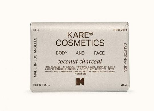 The product packaging features a minimalist, sophisticated design dominated by muted tones and clean typography. The layout is straightforward, emphasizing the brand name and product type with ample negative space to convey a sense of natural efficacy and premium quality.