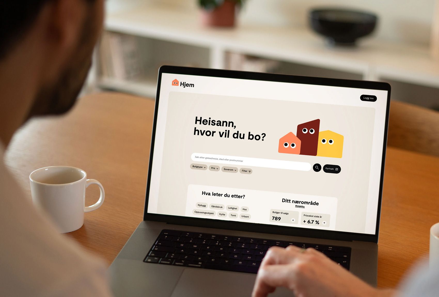 The image captures a close-up of a person interacting with a laptop displaying a clean, modern interface, likely a user onboarding or setup screen. The design emphasizes simplicity and clear calls to action through minimalist graphics and ample white space.