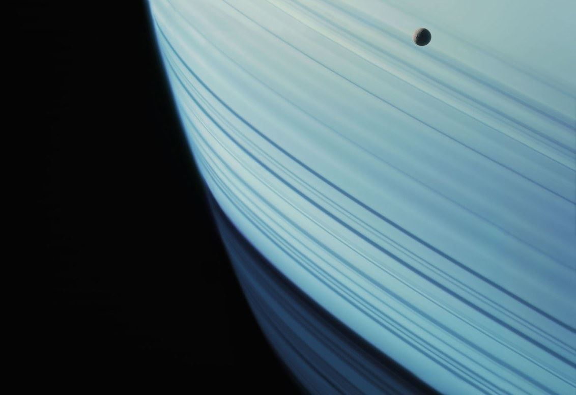 This image captures a close-up view of a celestial body, likely a planet or moon, emphasizing smooth curvature and subtle linear striations. The visual language is minimalist and focused on texture and scale, evoking a sense of vastness and alien beauty.