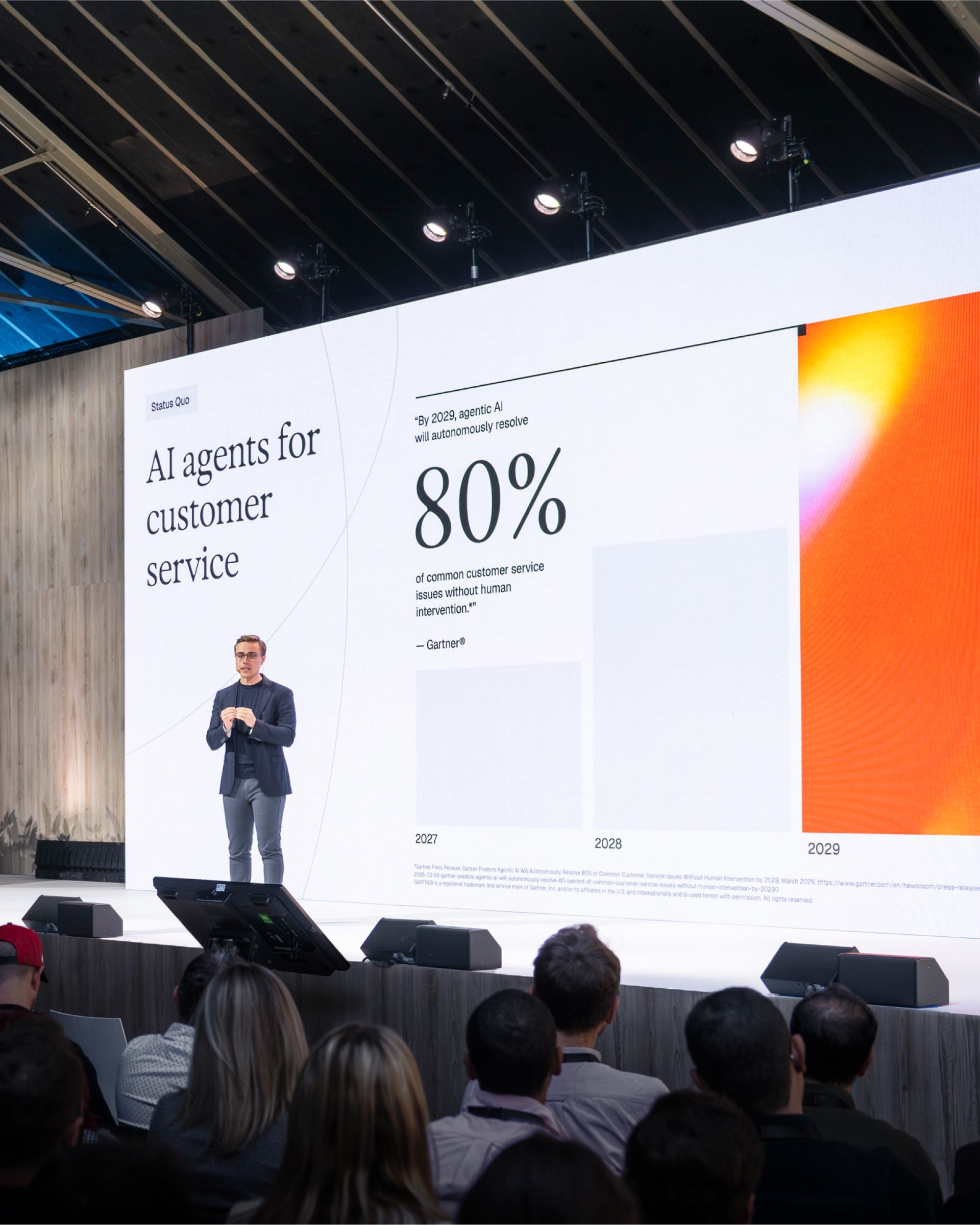 This image captures a professional, modern conference setting focused on technology and business data. The visual language is clean and minimalist, utilizing high-contrast elements to emphasize the presentation content and speaker. The overall feel is intellectual, forward-thinking, and corporate.