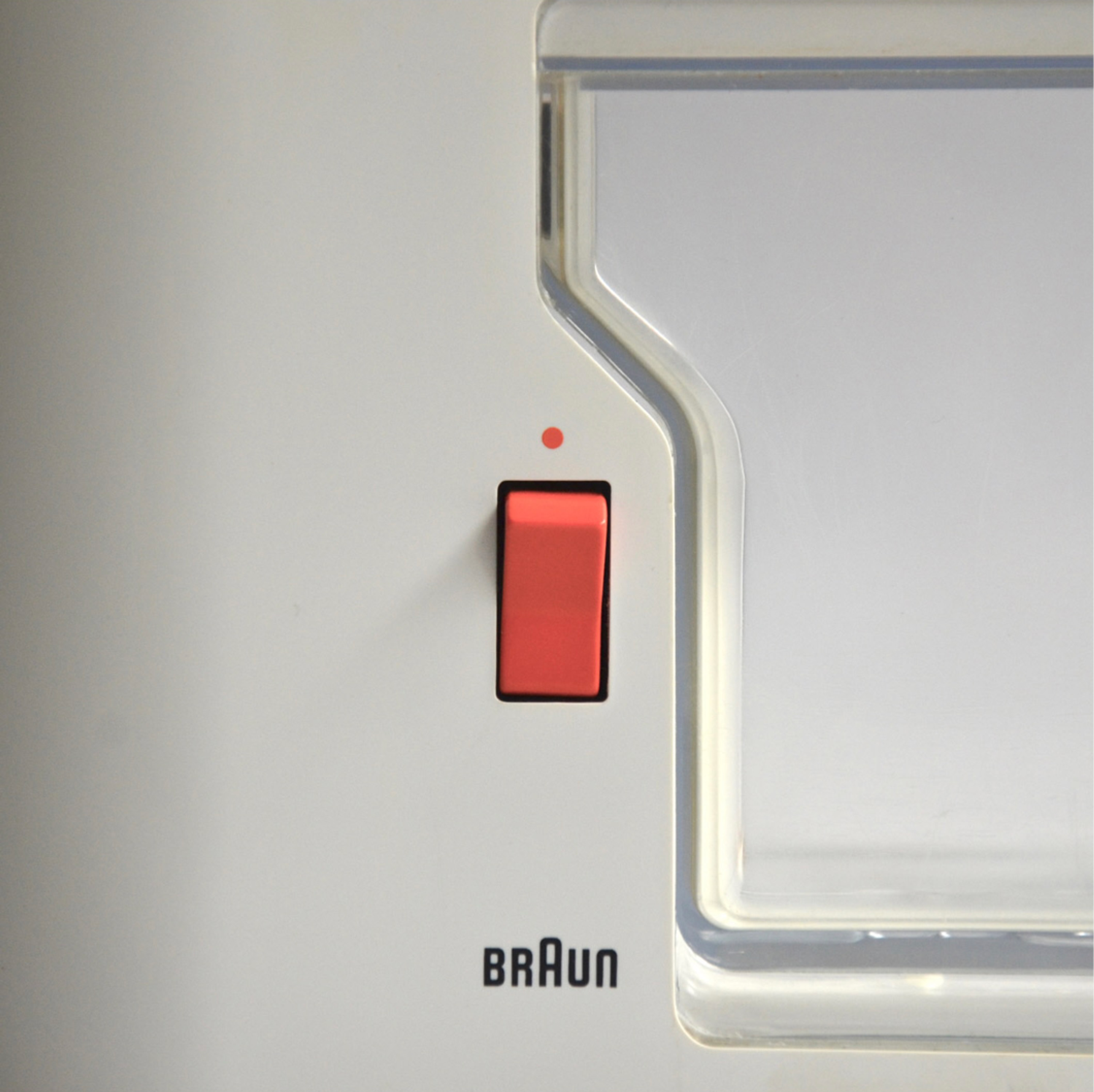 The image displays a minimalist interface element, likely a sensor or indicator, characterized by clean lines and a subtle use of color contrast. The design emphasizes functionality through simple geometric shapes and a translucent housing.