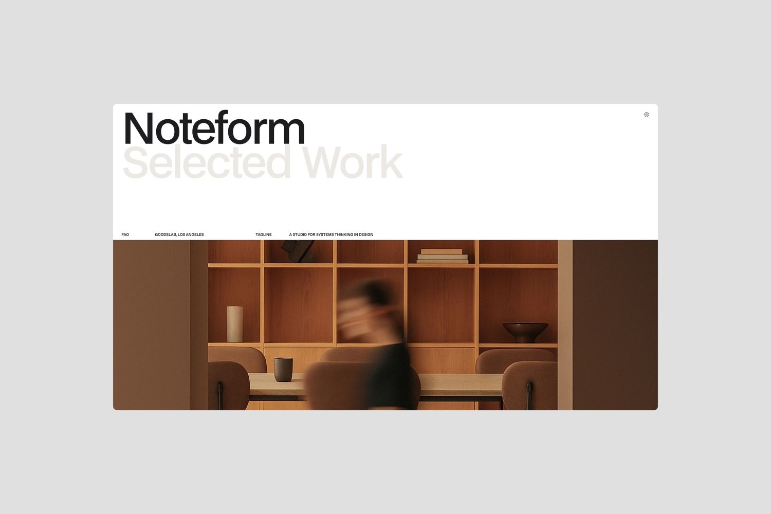 The image presents a clean, minimalist interface design juxtaposed against a warm, wood-toned background featuring blurred human activity. The visual language balances modern digital presentation with organic, tactile elements, creating a sophisticated and inviting atmosphere.