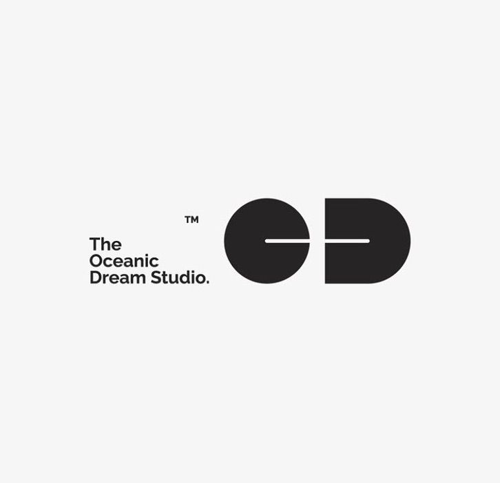 A minimalist logo design for 'The Oceanic Dream Studio' featuring geometric shapes and clean typography. The visual identity combines a circular and rounded rectangular form with a horizontal line connector, creating a modern, balanced composition. The design employs a stark black-and-white palette with sans-serif typography, conveying professionalism and contemporary sophistication.