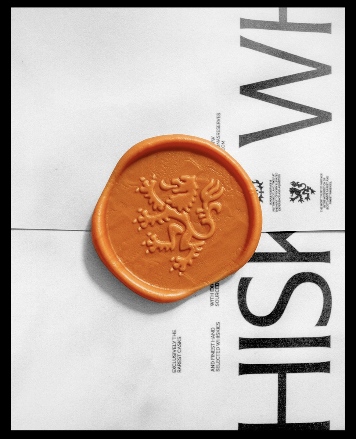 A minimalist design featuring a bold orange wax seal with an embossed heraldic lion, centered on a clean white background with large black sans-serif typography. The composition balances organic tactile elements with stark geometric letterforms, creating a sophisticated blend of traditional and contemporary aesthetics.