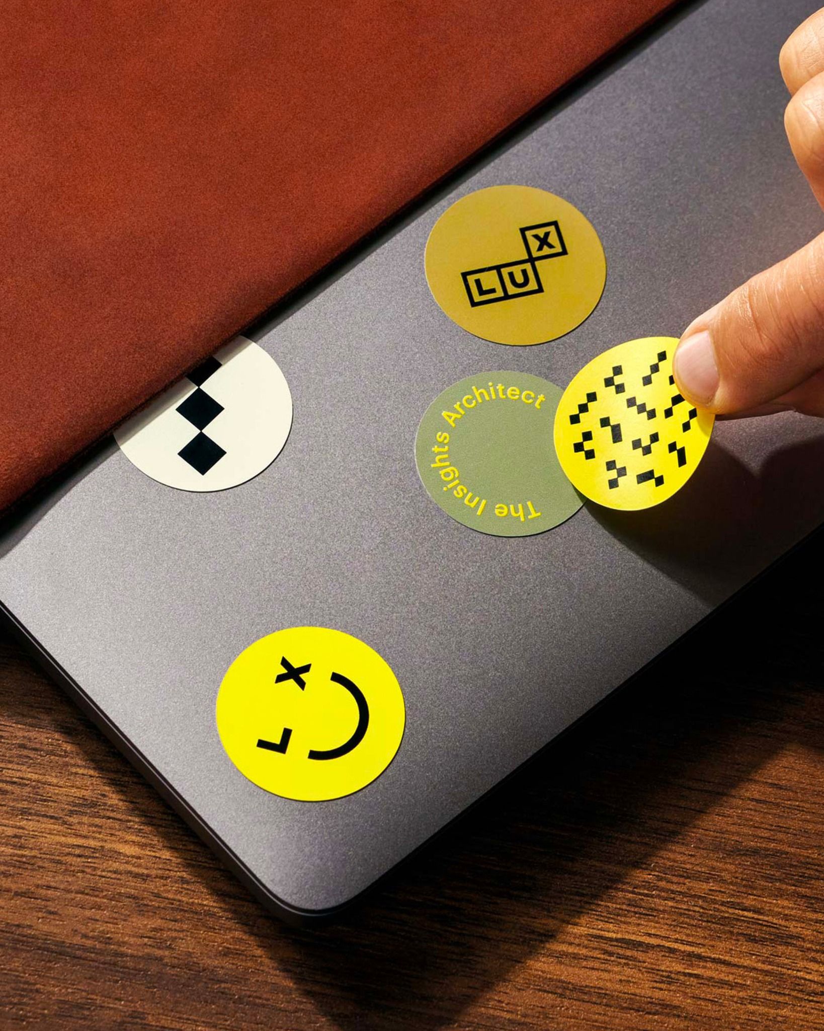 This image showcases a minimalist and tactile design aesthetic, utilizing a muted gray background contrasted with vibrant yellow and olive green circular elements. The visual language is clean, modern, and playful, suggesting an interface or a set of conceptual markers.