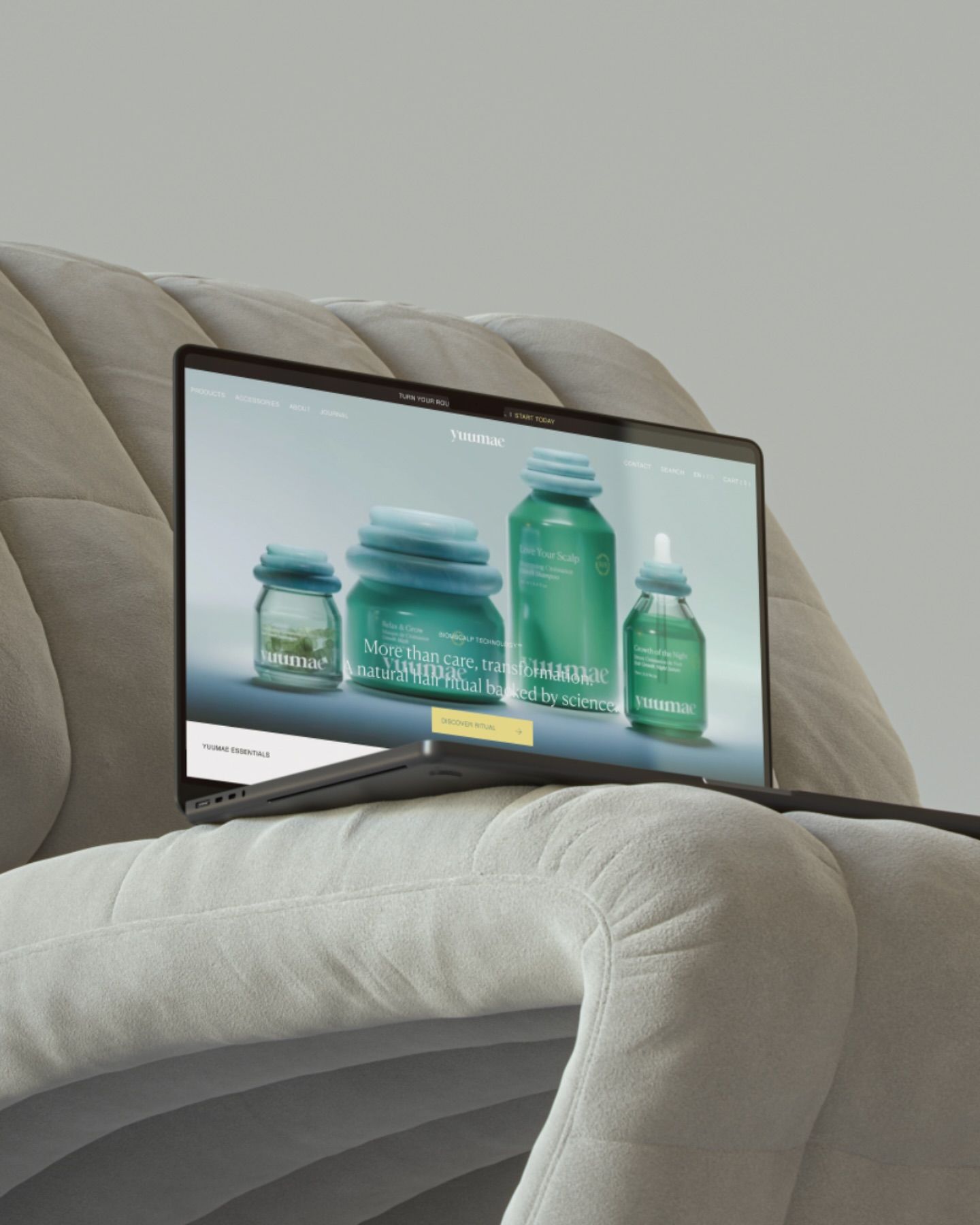 The image features a modern, minimalist setup showcasing a laptop screen displaying product imagery, suggesting a focus on clean aesthetics and natural or organic products. The composition is subdued, relying on soft textures and muted tones to create a calm and professional visual experience.