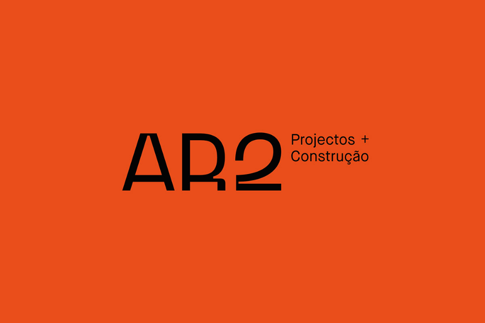This design employs a stark, high-contrast aesthetic using warm orange and sharp black typography to convey professionalism and strength. The minimalist layout focuses attention on the acronym 'AR2' while clearly defining the company's service sector through secondary text.