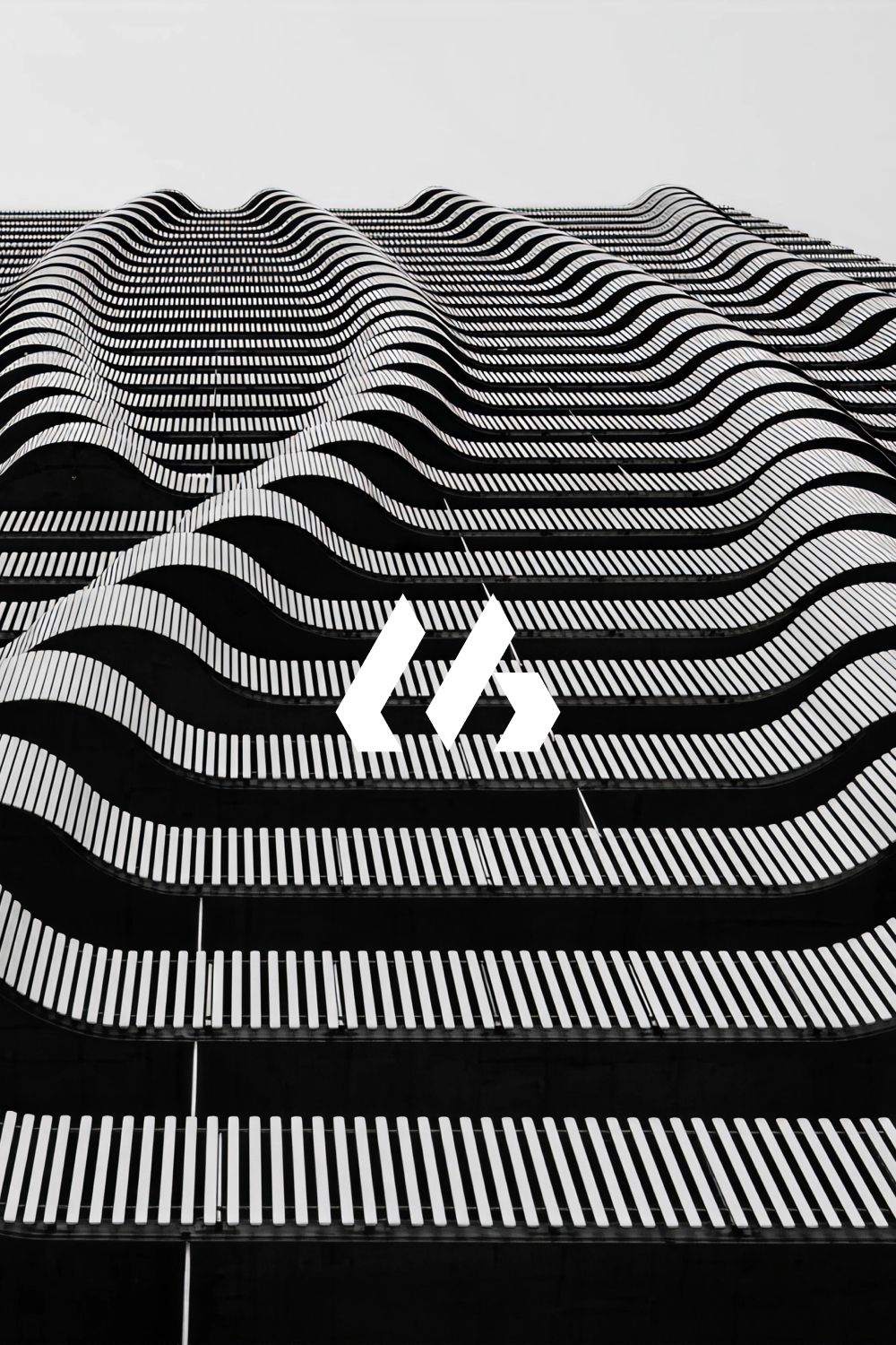 This image features a high-contrast, monochromatic pattern dominated by undulating, wave-like lines that create a sense of depth and movement across the frame. The design employs strong geometric repetition to establish a dynamic, almost topographical texture.