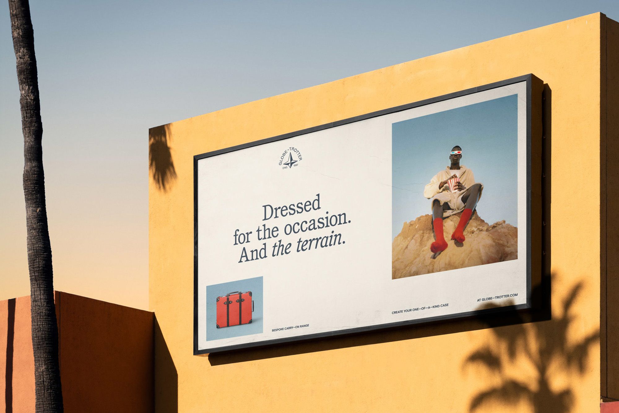 A minimalist outdoor billboard featuring a clean, modern layout with a lifestyle brand message. The design combines typography, product imagery, and a lifestyle photograph against a bright yellow architectural frame, creating a striking contrast with the clear sky backdrop.