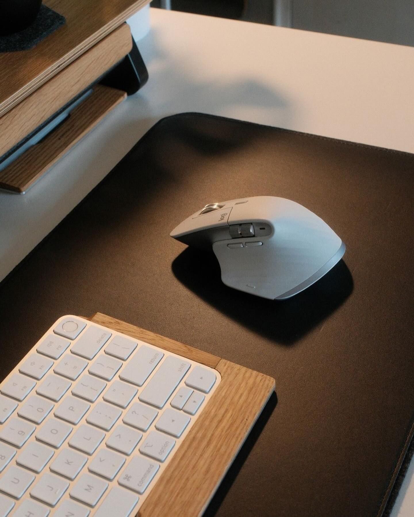 This image showcases a minimalist workspace blending natural wood textures with modern, functional technology. The visual language emphasizes clean lines, muted tones, and thoughtful arrangement, creating a serene yet highly productive atmosphere.