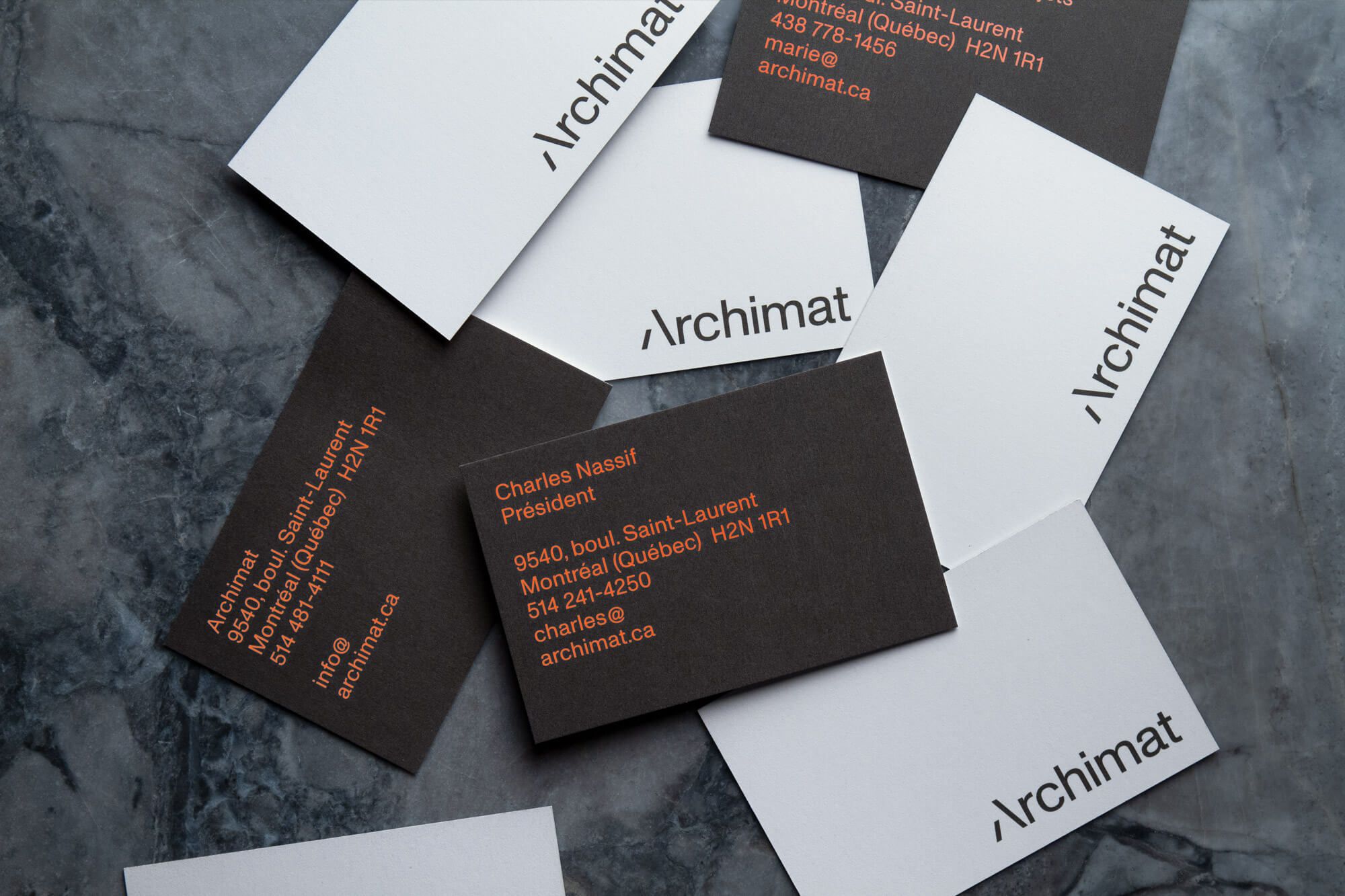 The image presents a minimalist and professional layout featuring dark and white cards, suggesting an identity or contact card set. The design relies heavily on negative space and clean typography to convey a sense of modern, corporate professionalism.