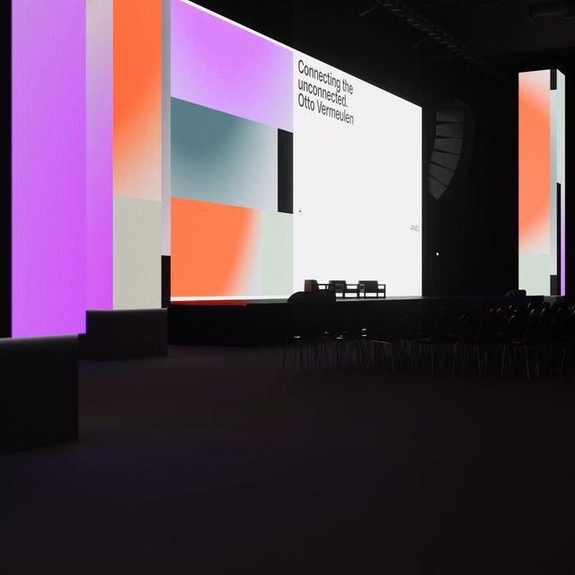 The image presents a modern, minimalist exhibition or gallery space characterized by large, brightly lit vertical panels featuring soft gradients of color. The design emphasizes clean lines, geometric shapes, and a sophisticated interplay between solid blocks of color and negative space.