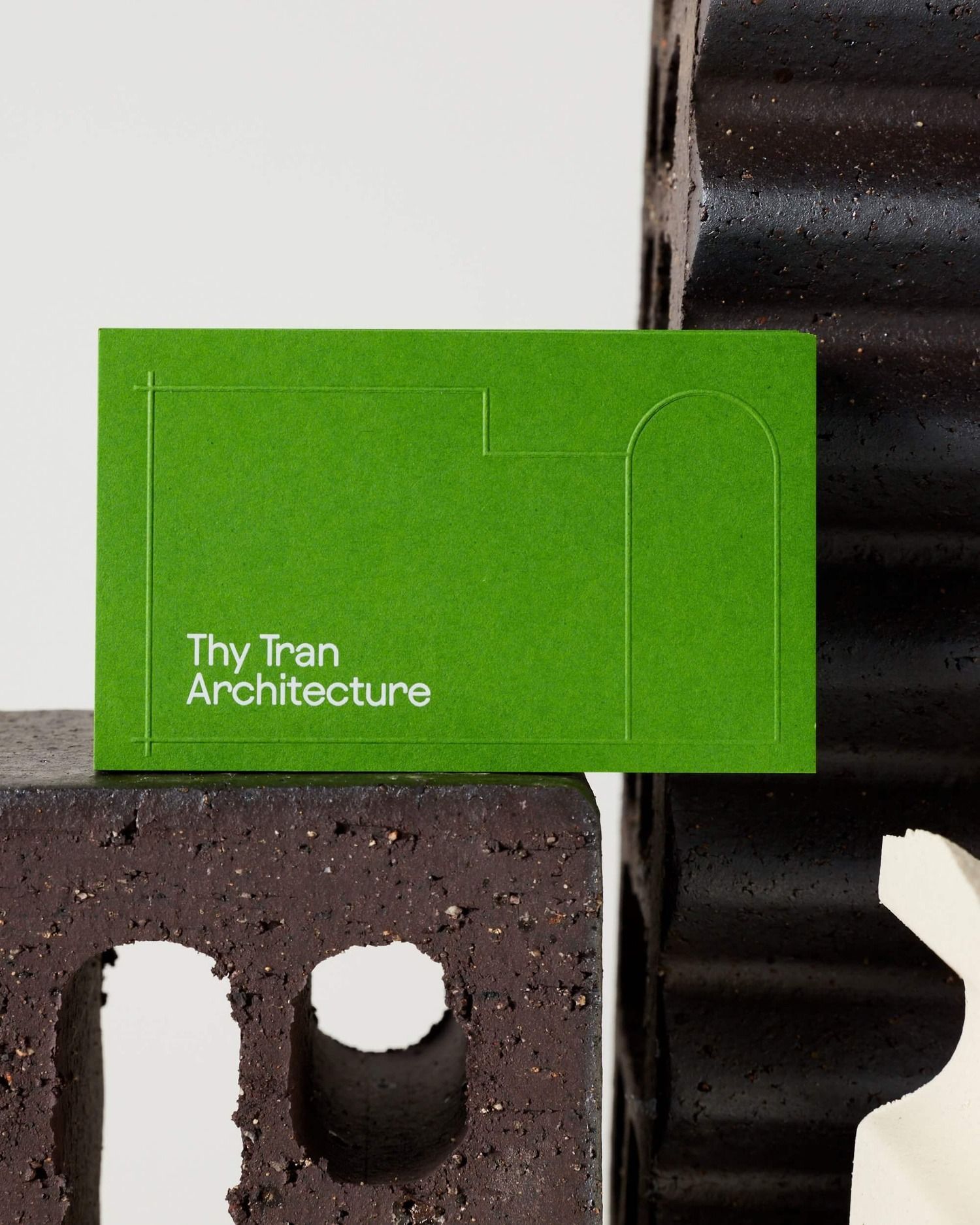 The image presents a clean, minimalist design featuring a vibrant lime green card set against dark, textured surfaces. The visual language emphasizes simplicity, modern functionality, and a strong contrast between the smooth graphic element and the rough background.