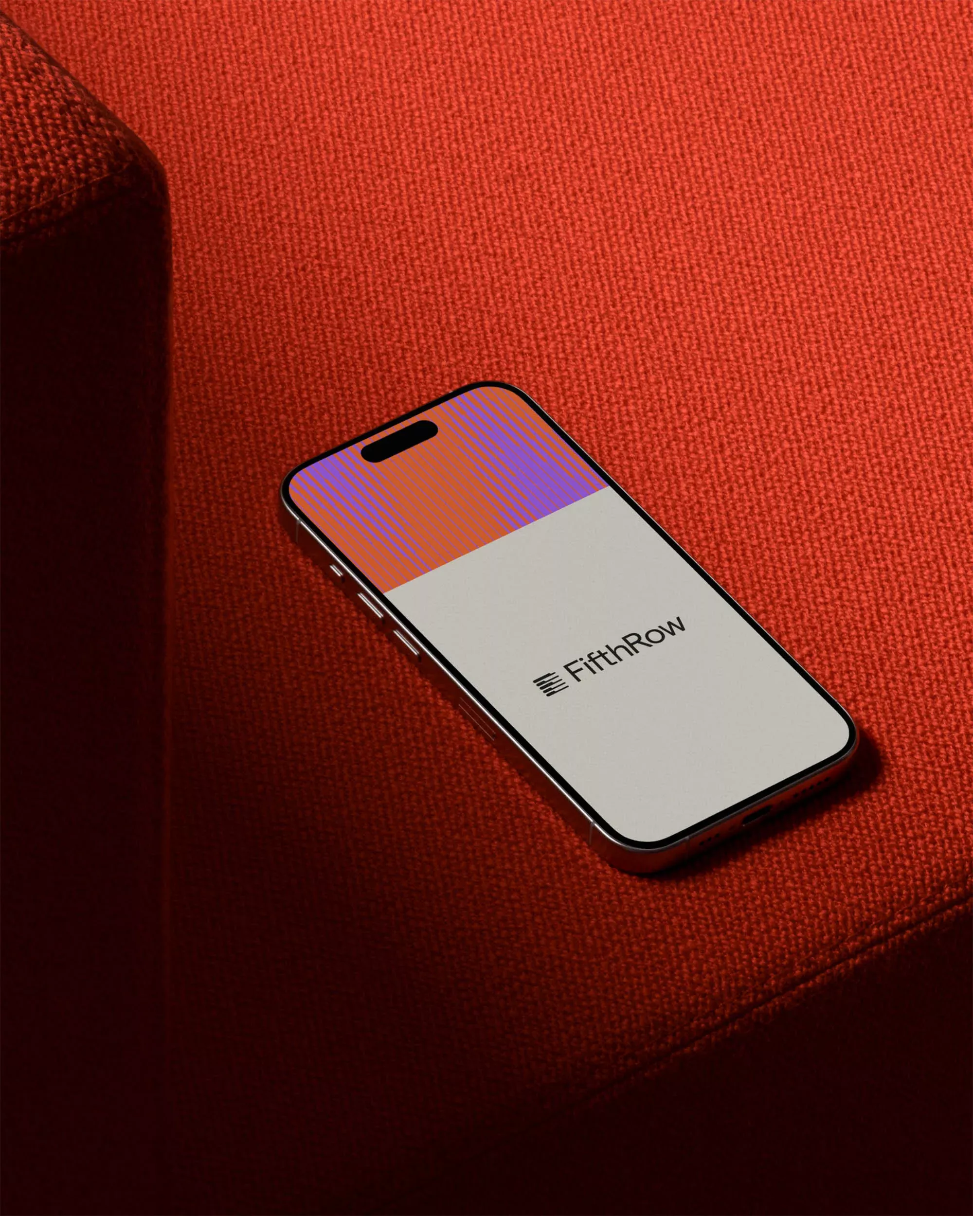 This is a high-quality product shot featuring a smartphone displayed against a rich, textured background. The design utilizes a vibrant color gradient on the screen to create depth and modernity, emphasizing warmth and sophisticated branding.