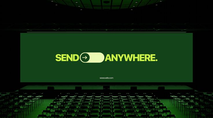 The image presents a dark, high-contrast presentation screen dominating the frame, featuring clean, modern typography against a deep olive green background. The design is minimalist and corporate, emphasizing a clear call to action ('SEND -> ANYWHERE') with a sense of expansive possibility.
