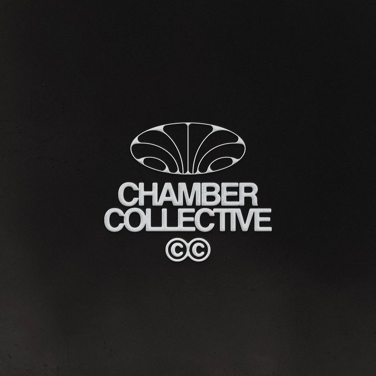 A minimalist logo design featuring geometric Art Deco-inspired iconography paired with bold, modern typography. The composition uses a clean, centered layout with a stylized shell or fan motif above the wordmark, creating a sophisticated and contemporary brand identity against a dark background.