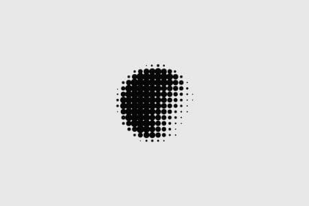 The image is a minimalist abstract composed entirely of densely packed black dots forming a circular or slightly irregular shape. It utilizes negative space effectively to create texture and focus on pattern.