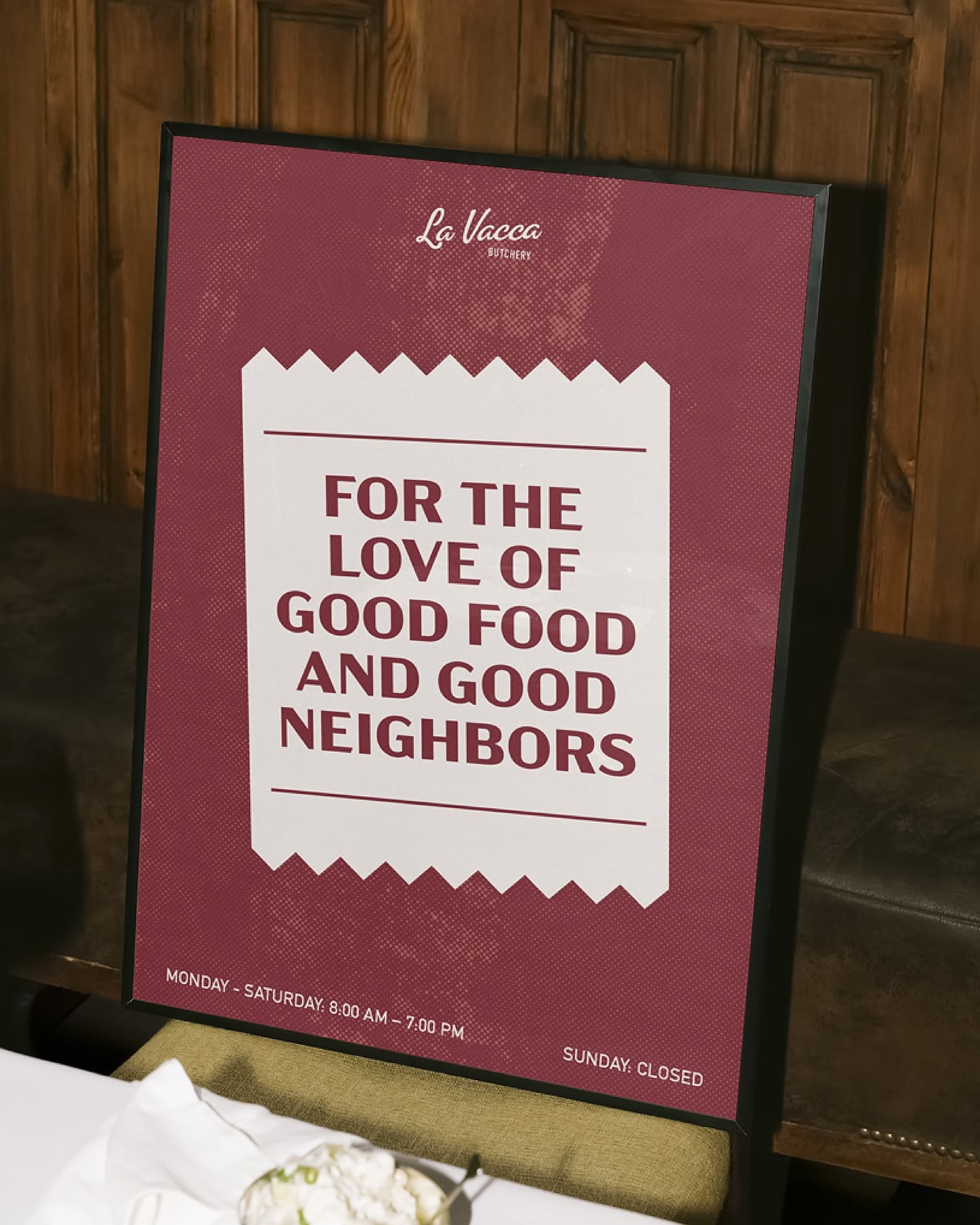 This design employs a classic, rustic aesthetic using deep reds and off-white to convey a sense of established quality and warmth. The composition is clean and highly structured, creating a clear visual hierarchy that effectively communicates the business name and event details. The overall feeling is inviting, traditional, and focused on community and good food.