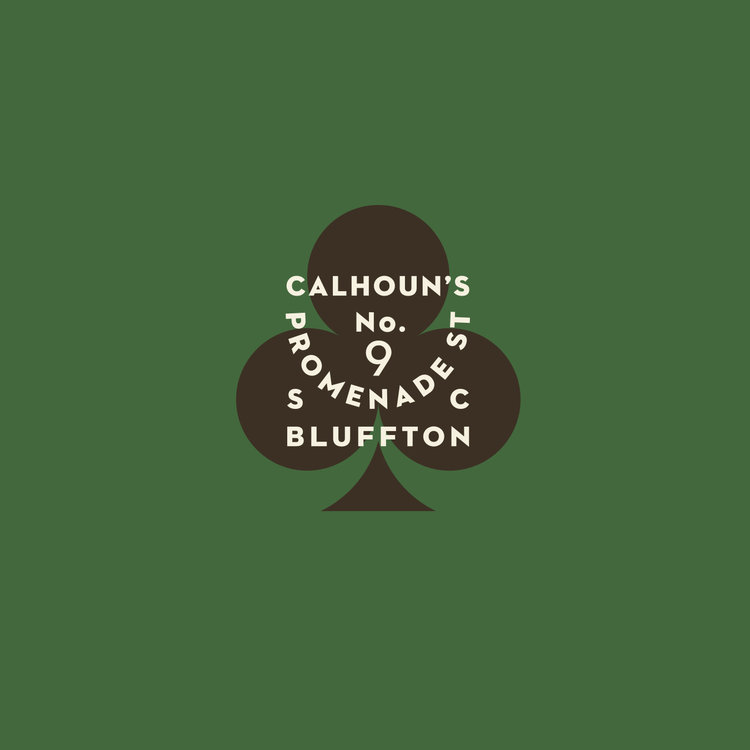 A vintage-inspired logo featuring a stylized club suit symbol with integrated circular typography, set against a muted sage green background. The design combines classic playing card aesthetics with mid-century modern sensibilities, creating a sophisticated and nostalgic visual identity.