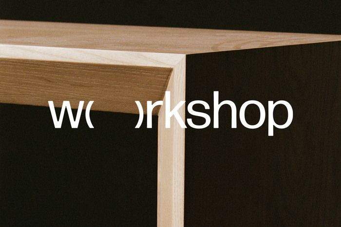 A minimalist architectural photograph featuring clean geometric lines formed by natural wood beams intersecting against a dark background. The composition emphasizes negative space and structural simplicity, with bold white typography overlaid across the frame. The design conveys a contemporary, gallery-like aesthetic with strong emphasis on form and contrast.